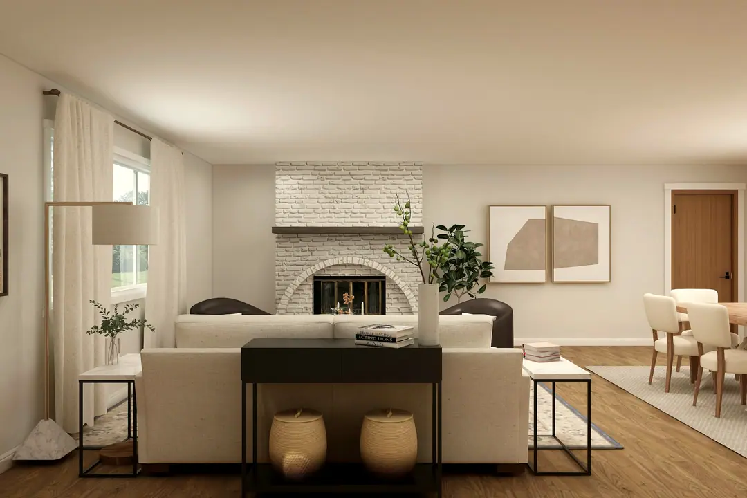 Salón con chimenea blanca y comedor al fondo